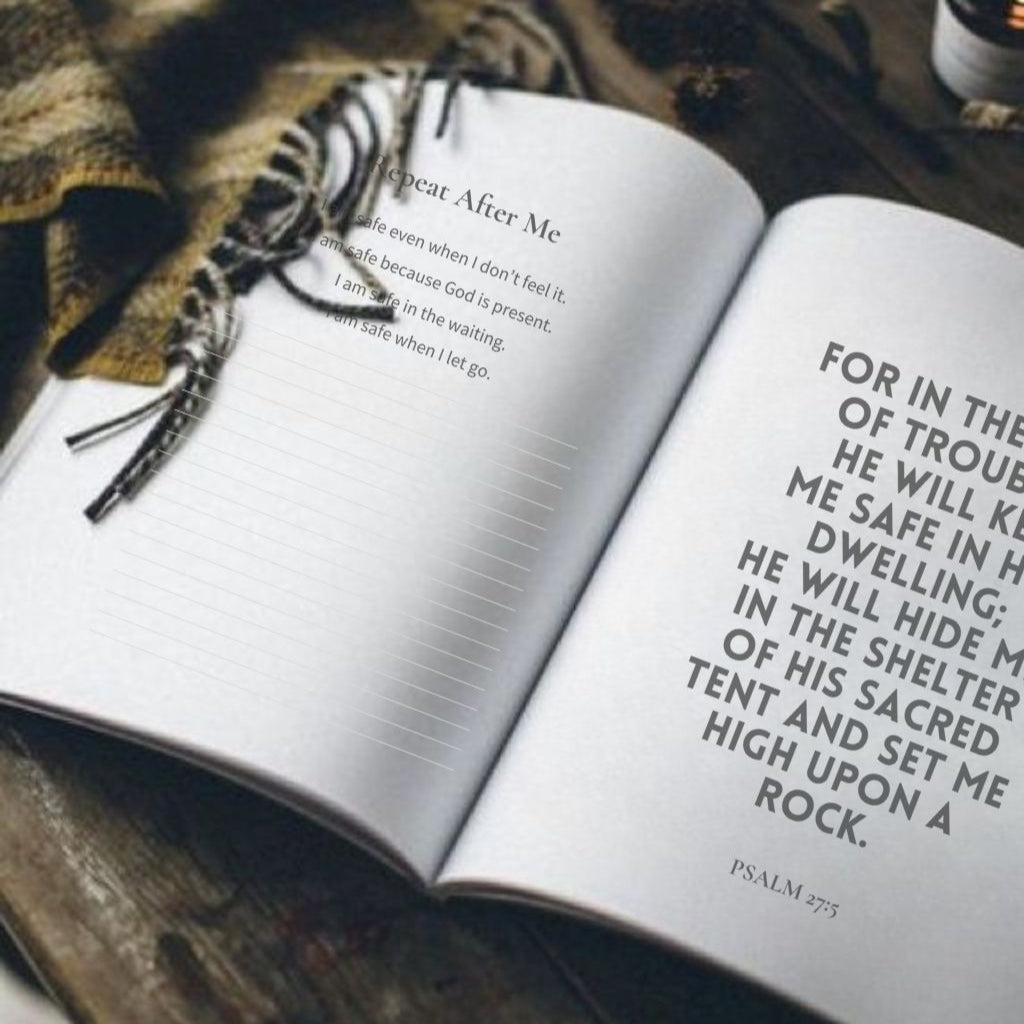 Open book with a prayer on a wooden surface with a cup and candle.