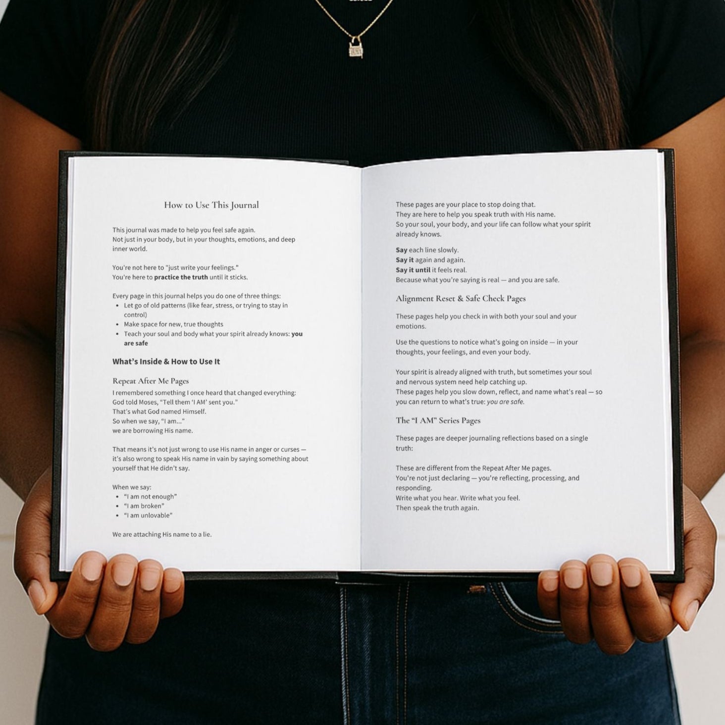Person holding an open book with text on a white background