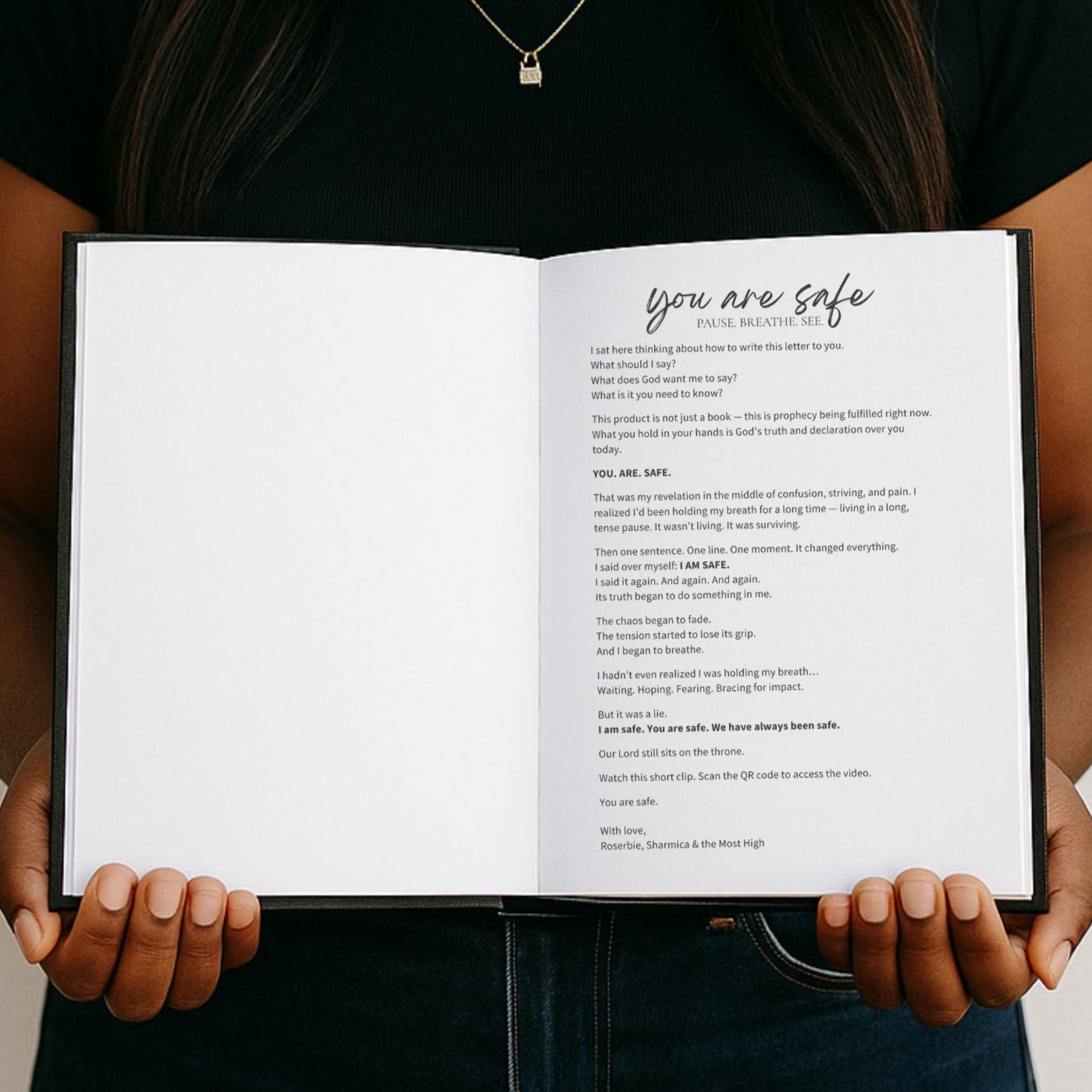 Person holding an open book titled 'You are safe' against a white background