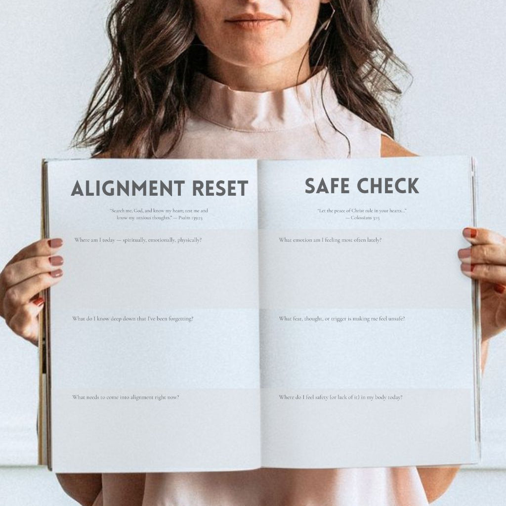 Woman holding an open book titled 'Alignment Reset' and 'Safe Check' against a white background