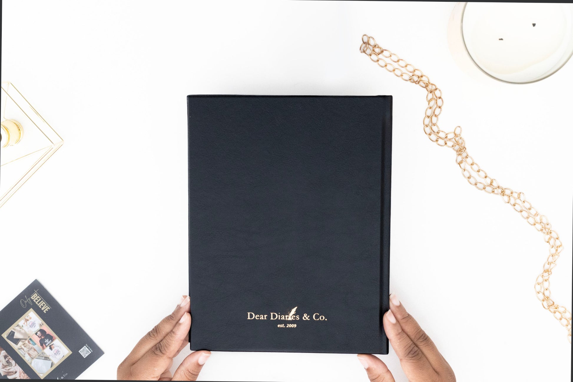 Minimalist back cover of the I AM SAFE journal with sleek, understated design. with 'Dear Diaries & Co.' branding held by hands on a white surface.