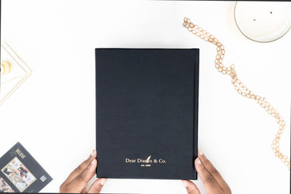 Minimalist back cover of the I AM SAFE journal with sleek, understated design. with 'Dear Diaries & Co.' branding held by hands on a white surface.