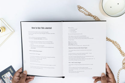 Open I AM SAFE  journal with instructions on a white surface with decorative items.